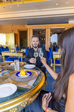 Smiling man toasting with champagne during romantic luxury dinner date
