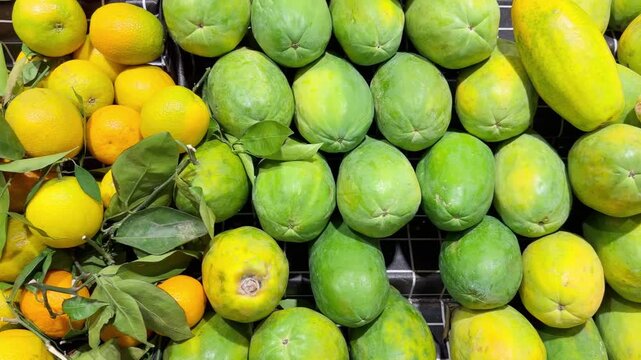 Fresh Tropical Fruits on Display in Supermarket Produce Section &ndash; Assorted Mangoes, Dragon Fruit and Passion Fruit Stacked at the Vegetable Counter