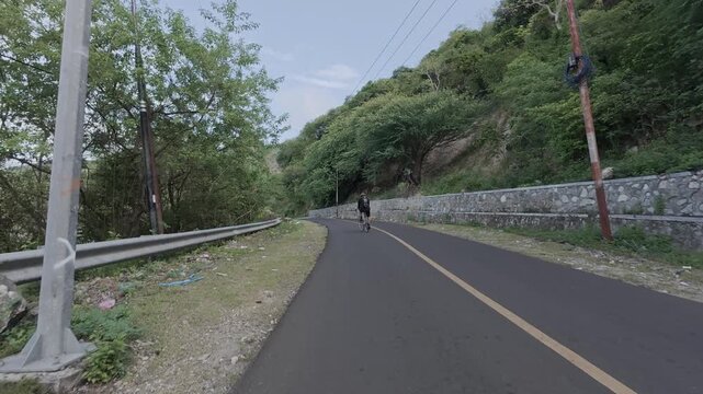 Cyclist Riding on Scenic Mountain Road