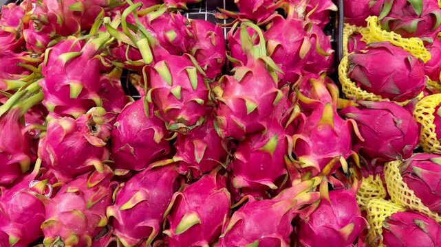 Fresh Tropical Fruits on Display in Supermarket Produce Section &ndash; Assorted Mangoes, Dragon Fruit and Passion Fruit Stacked at the Vegetable Counter