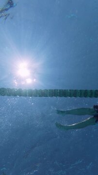Low Angle View of Man Swimming Front Crawl in Sunny Pool