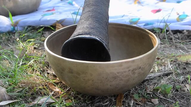 Handmade forged Tibetan singing bowl made of metal alloy. Ancient musical instrument used for meditation, relaxation, yoga and sound therapy.