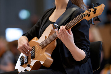 Fototapeta premium Musician plays bass at city hall concert