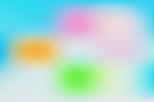 Abstract colorful gradient background with soft grainy texture and vibrant light spots.