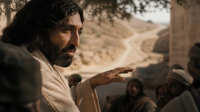 Jesus teaching a crowd beside an ancient desert road. Biblical scene from the parable of the Good Samaritan, illustrating compassion, mercy, faith, and love for ones neighbor.