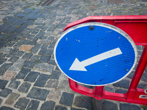 Directional Arrow Sign Road Traffic Blue Detour Metal Weathered Barrier Cobblestone Street Regulation Closeup Urban