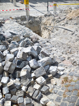 Construction Cobblestone Excavation Trench Street Repair Urban Infrastructure Stone Pile Caution Renovation Road Site Work