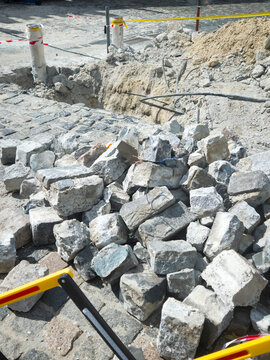 Construction Cobblestone Excavation Trench Street Repair Urban Infrastructure Stone Pile Caution Renovation Road Site Work