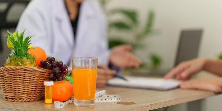 Nutritionist consulting with patient about healthy diet and meal planning in clinic