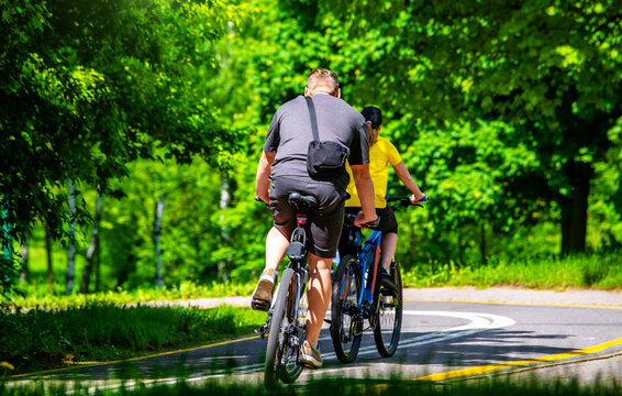 Cyclists ride on the bike path in the city Park
