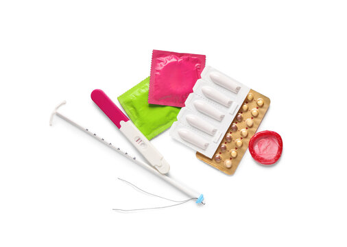 Various birth control methods and a positive pregnancy test on a white background, family planning and reproductive health