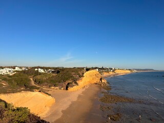 view from the cliffs to the Cala del Puntalejo and the Búnker de Fuente del Gallo at the Atlantic Ocean near Conil de la Frontera during sunset, Cadiz, Costa de la Luz, Andalusia, Spain © keBu.Medien