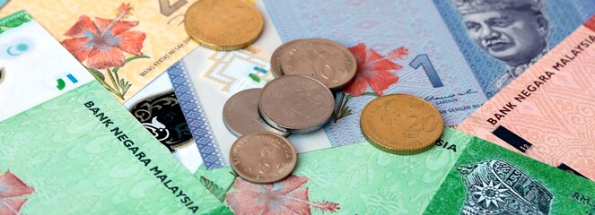 Malaysian ringgit money banknotes and coins on table. Malaysia cash bills of MYR currency © Viktor