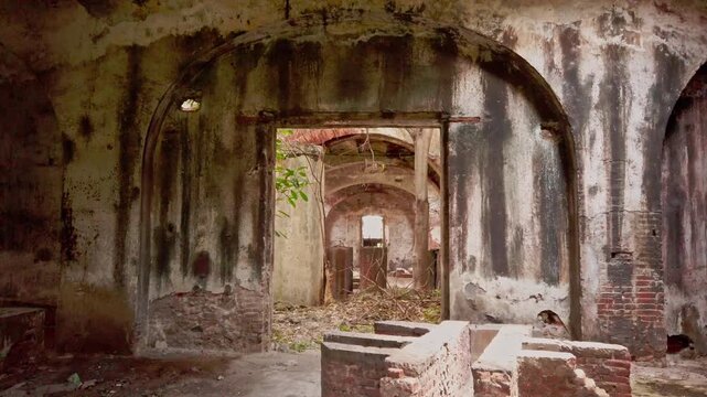 Interior view of the abandoned Hacienda Oacalco in Morelos Mexico featuring arched hallways weathered walls brick remains colonial architecture and natural light