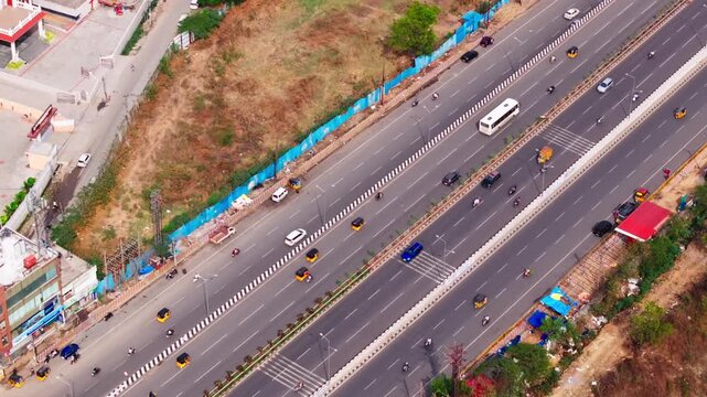 National highway 65 with 6 lane road bhel flyover, traffic flow, rumble strips and St. Arnold's High School at ramachandrapuram, hyderabad, telangana, india. day time, zib shot, drone shot, 4k.