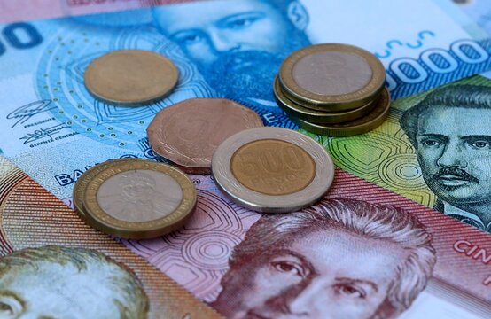 Chilean peso money banknotes and coins on table. Chile cash bills of CLP currency