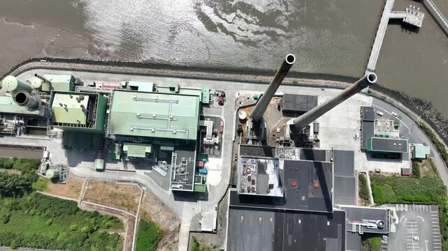aerial down view of Cooling towers.Detailed aerial views of electricity infrastructure.4K drone footage of electricity production infrastructure along the River Suir, Wexford, Ireland.