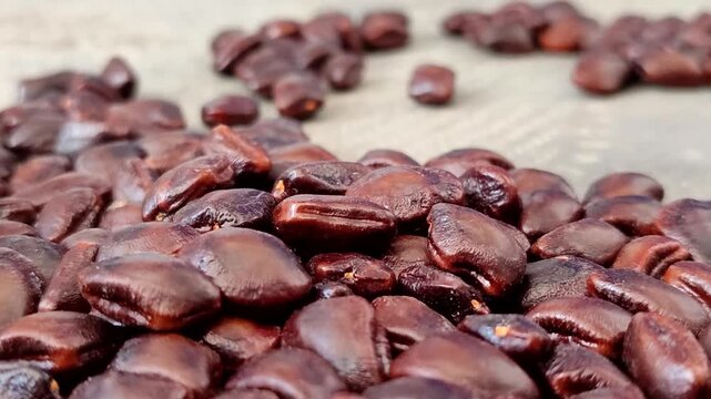 Closeup of fresh brown tamarind seeds piled.  Tamarind seeds are effective for relieving dry eyes, lowering cholesterol, aiding digestion, and serving as a natural wastewater purifier