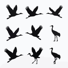 Naklejka premium Flying Crane Bird Silhouettes Set Vector Illustration of Wild Herons in Various Poses