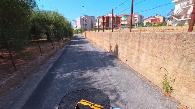 Cycling Down a Village Street Lined With Houses, Pietra Ligure, Italy - POV VIDEO