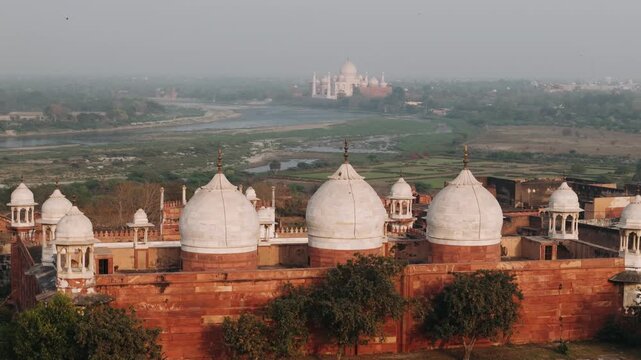 Agra fort moti masjid panning revealing the iconic taj mahal across the yamuna river in india during a hazy day