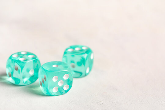Turquoise game dices on white background