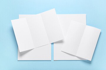 Fototapeta premium Different blank brochures on blue background