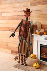 Fototapeta premium Interior of festive living room with Spooky Halloween monster and autumn decorations on fireplace