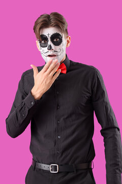 Shocked young man dressed for Halloween on color background