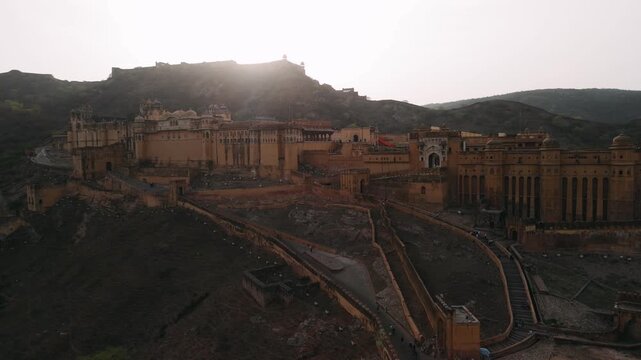 Aerial view of amer fort, a historic rajput architecture fortress on a hill near jaipur, rajasthan, with morning sun flare
