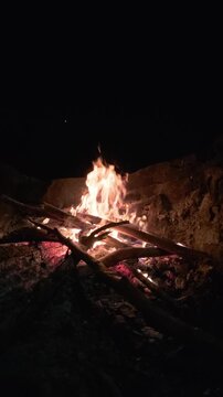 Slow Motion Campfire Burning Brightly in Stone Fire Pit at Night