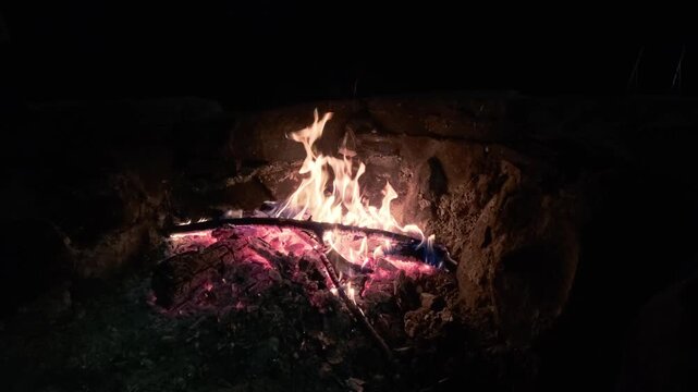 Slow Motion Campfire Burning Brightly in Stone Fire Pit at Night