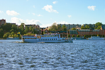 Naklejka premium Passenger vessel cruising Riddarfjärden in central Stockholm, Sweden