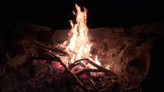 Slow Motion Campfire Burning Brightly in Stone Fire Pit at Night
