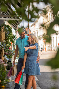Woman pointing out a shop display to her partner