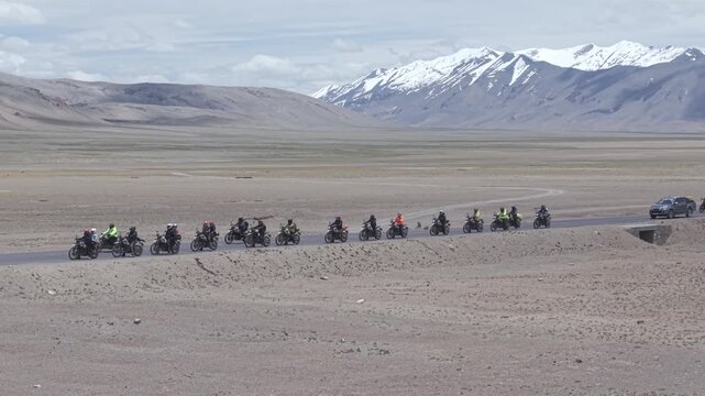 Aerial View of Tourists bike Riding Through Himalayan Valley in Ladakh India