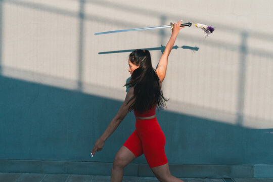 Chinese young woman practicing wushu kung fu.