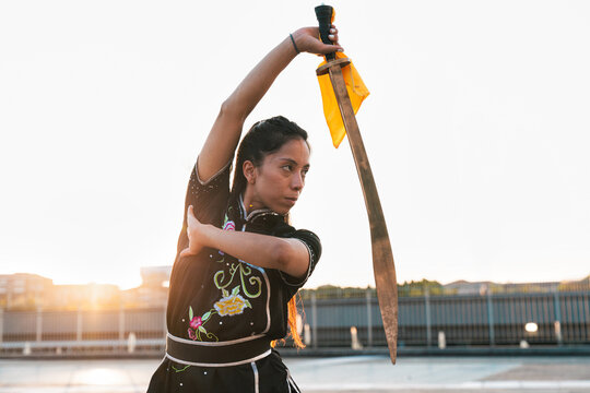 Chinese young woman practicing wushu kung fu.