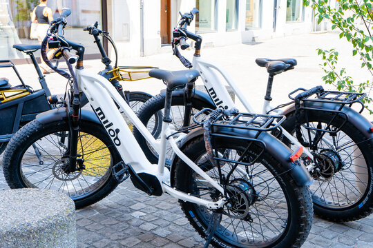 White Miloo Electric Fat Bikes Parked on Cobblestone Street. Zurich, Switzerland - June 23, 2026