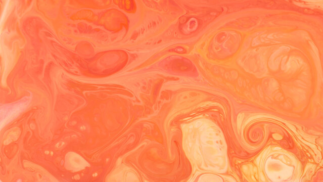 Abstract liquid background with swirling coral orange and peach marbled fluid pattern