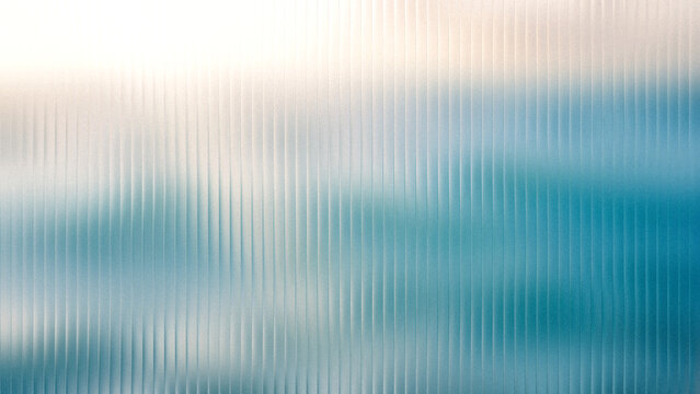 Abstract rippled glass texture with soft blue and white bokeh background for design concept