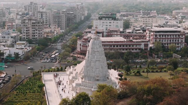 Aerial view of birla mandir hindu temple in jaipur with cityscape and traffic in the background on a sunny day