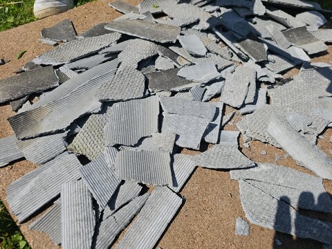 Broken pieces of material scattered on the ground during a construction project concept