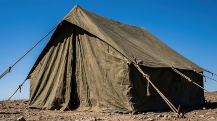 Military-style tent set against a clear blue sky © Dmitry