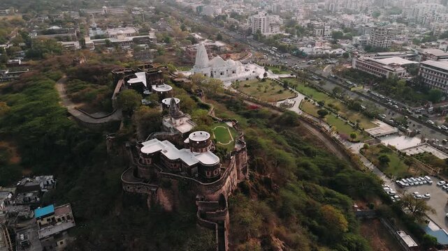 Aerial view of birla mandir hindu temple and moti dungri fort sitting atop a hill overlooking jaipur city in rajasthan, india