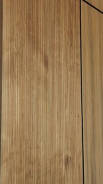 Vertical video. Natural wood texture fills the frame, showing fine grain and refined interior.