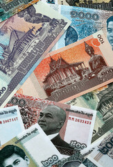 Cambodian riel money banknotes pile on table. Cambodia bills of KHR currency close up © Larysa
