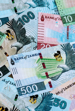 Zambian kwacha money banknotes pile on table. Zambia bills of ZMW currency close up