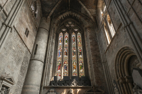 Worcester, England, United Kingdom - 21 July 2026: View of the intricate stained glass window inside Worcester Cathedral, featuring religious figures and stone gothic arches.
