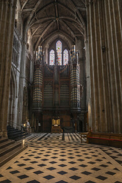 Worcester, England, United Kingdom - 21 July 2026: View of the pipe organ and stained glass windows inside Worcester Cathedral, featuring a checkered stone floor and vaulted ceilings.